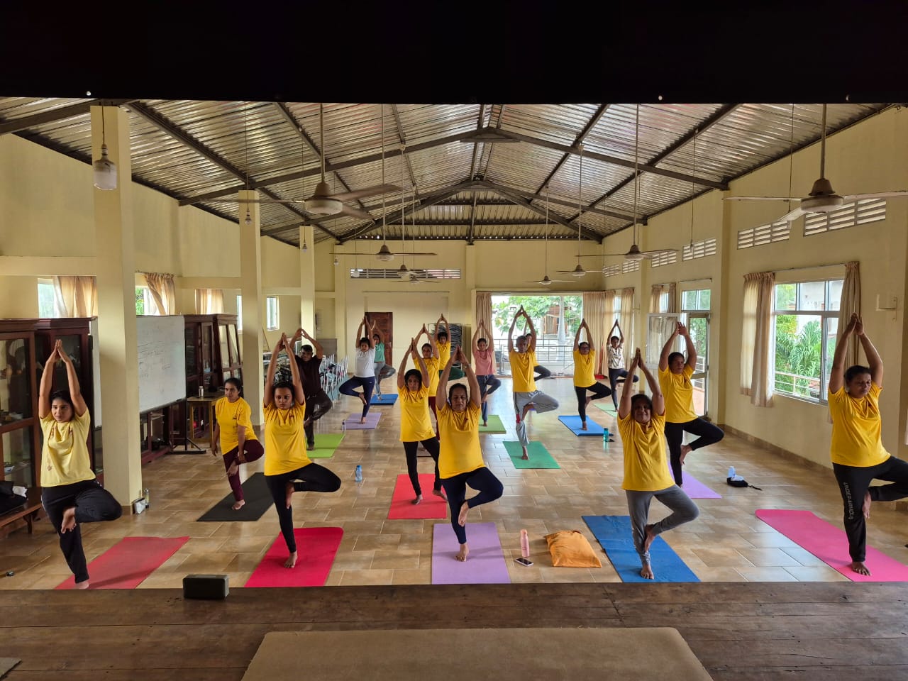 Ashtanga Yoga Lanka class holding tree pose in a large shala